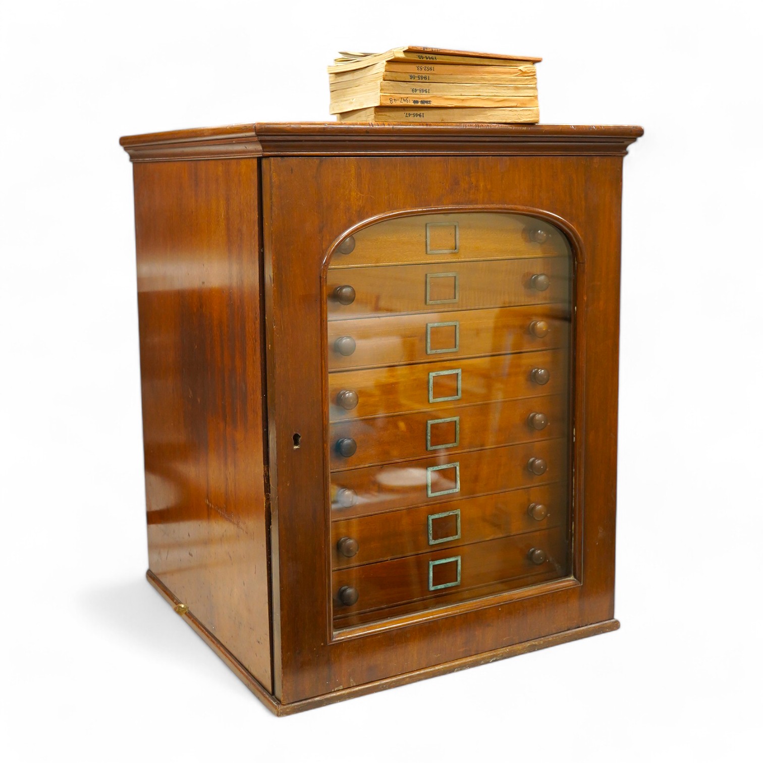 A Victorian mahogany 10-drawer collector’s cabinet with arched glazed door, height 68cm, width 54cm, depth 53cm, containing prepared and pinned moth and butterfly specimens, together with seven 1940s volumes of the Proce